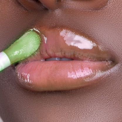 Swatch of Pink Lipps Taurus Glow Lip Oil on deep skin tone – sheer tint, green apple scent enhancing natural lip color with shine