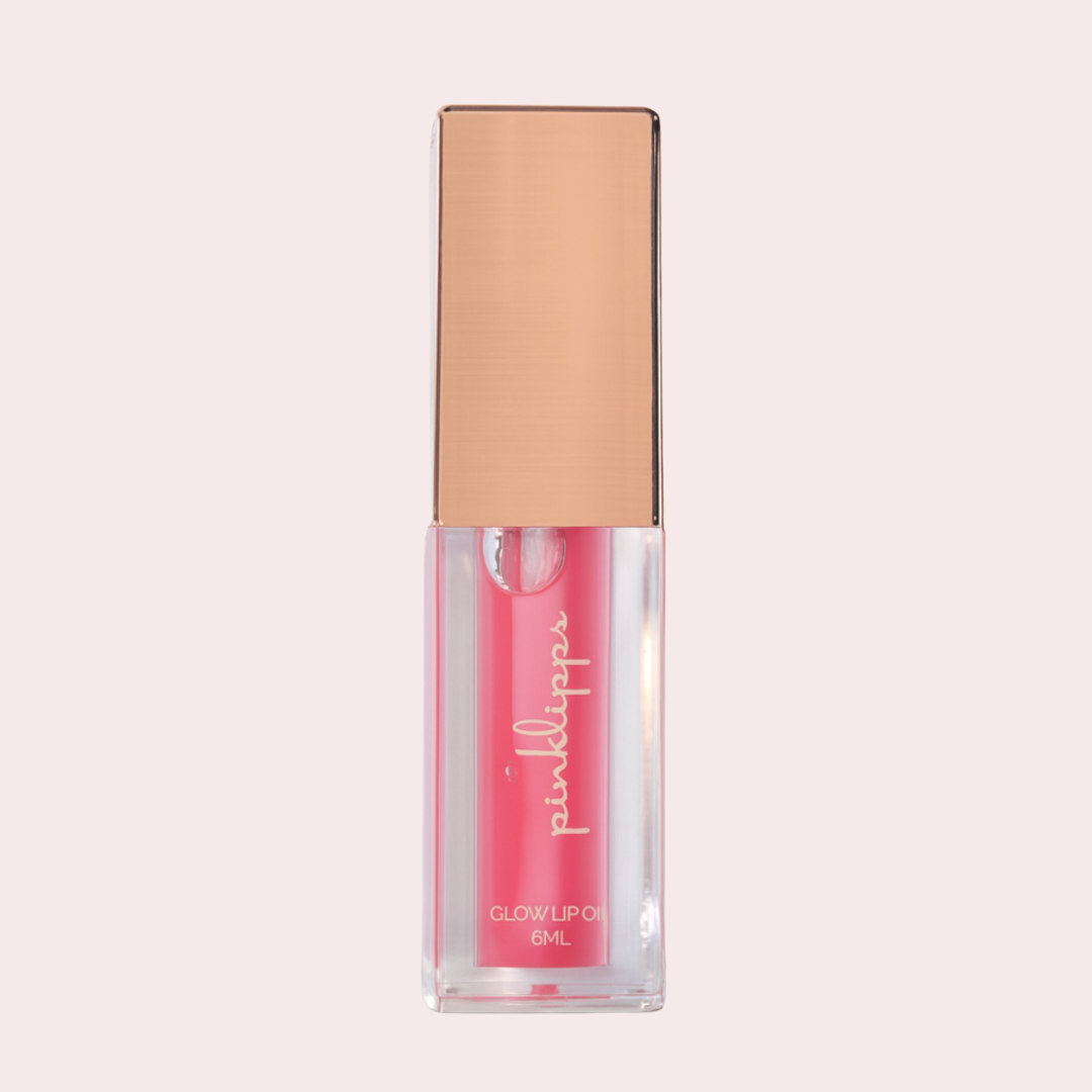 Pink Lipps 'Blossom' Glow Lip Oil tube on white background, strawberry scent vegan high-shine pink lip oil for every shade of melanin.