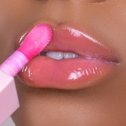 Lip model shot of pink Blossom Glow Lip Oil applied over medium skin tone – radiant glass finish with hydrating glow.