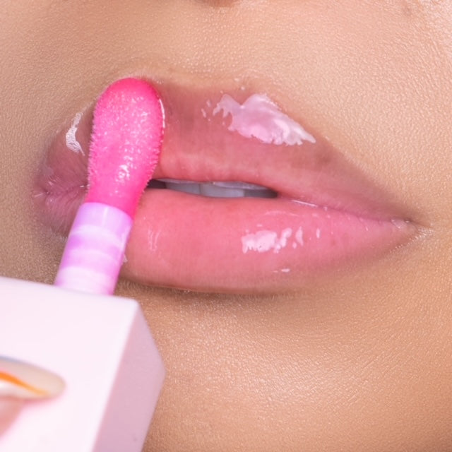 Lip model shot of pink Blossom Glow Lip Oil applied over light skin tone – radiant glass finish with hydrating glow.