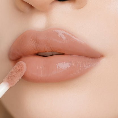 Lip-on model shot: Blush Nude Glass Gloss applied on fair skin tone — pigmented high-shine finish