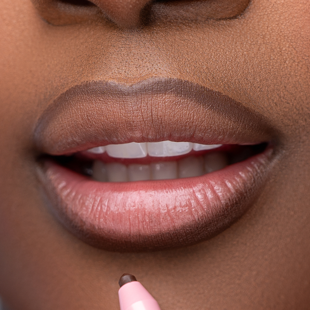 Lip model of Pink Lipps Everlasting 'Cool Brown' Lip Liner showcasing cool tone brown on melanin skin tone and lips