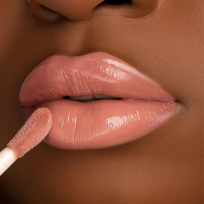 Lip-on model shot: Expose Me Nude Glass Gloss applied on medium skin tone — pigmented high-shine finish
