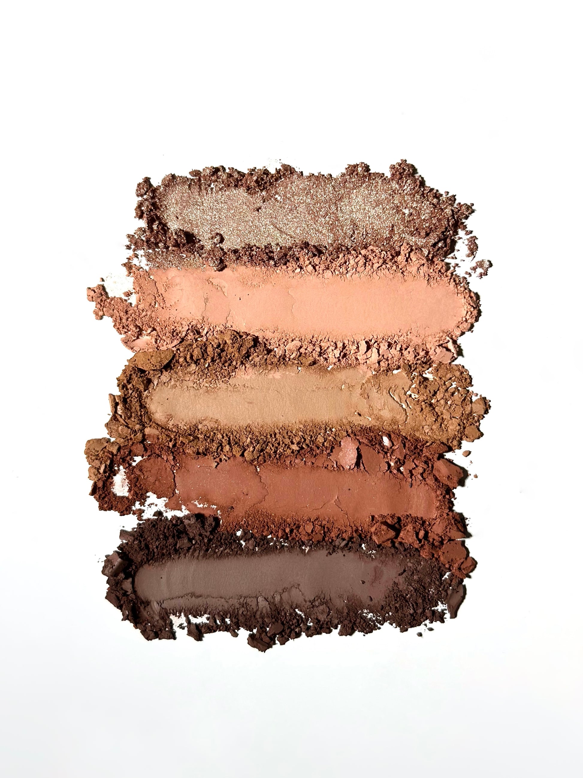 Swatch of Pink Lipps Fall Sweet Fall Eyeshadow Palette shades smeared on white background showing warm bronze, golden, and caramel-matte finishes