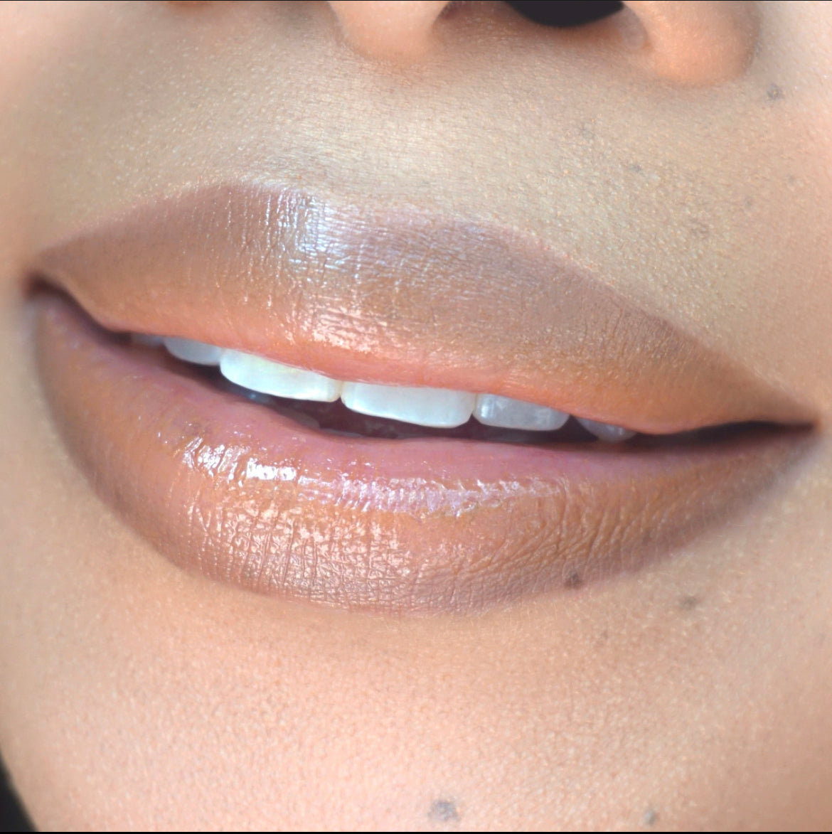 Swatch of Pink Lipps Lumi Balm Lip Tint shade ‘Fantasy’ on deep skin tone – rich nude tint designed to enhance melanin tones