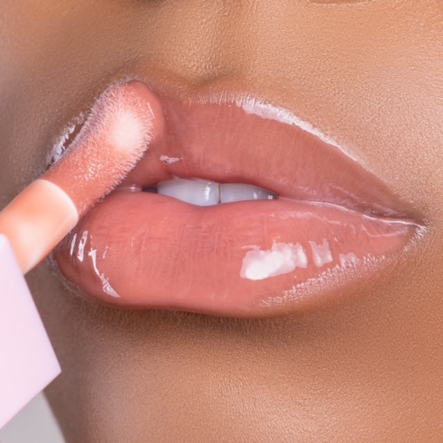 Lip model shot of nude Halo Glow Lip Oil applied over medium skin tone – radiant glass finish with hydrating glow.