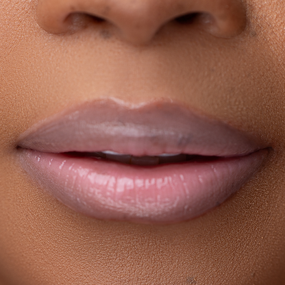 Close-up of LippEase Tinted Lip Treatments Power showing glossy pink high shine finish on light skin tone.