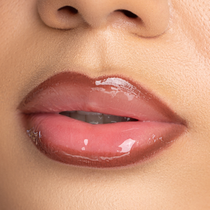 Lip-on model shot: Strip Nude Glass Gloss applied on light skin tone — pigmented high-shine finish