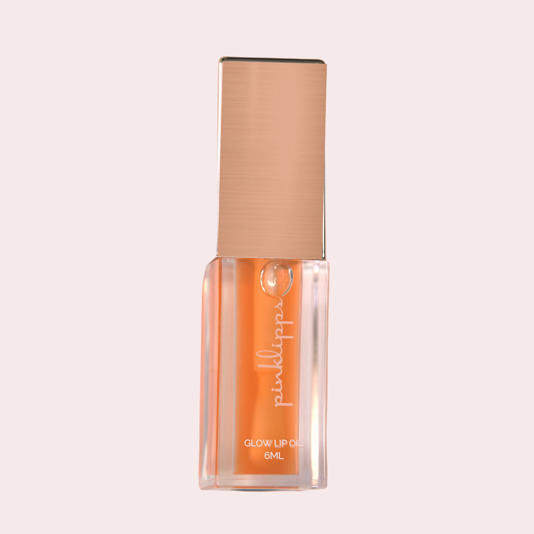 Pink Lipps 'SunGlow' Glow Lip Oil tube on white background, oranges scent vegan high-shine orange lip oil for every shade of melanin.
