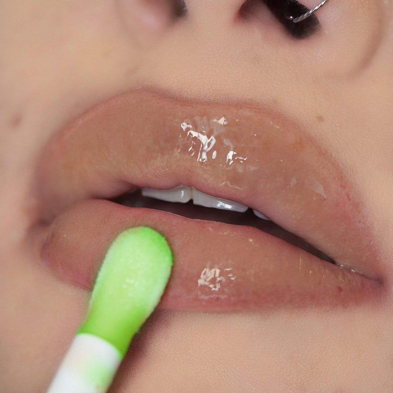 Swatch of Pink Lipps Taurus Glow Lip Oil on light skin tone – sheer tint, green apple scent enhancing natural lip color with shine