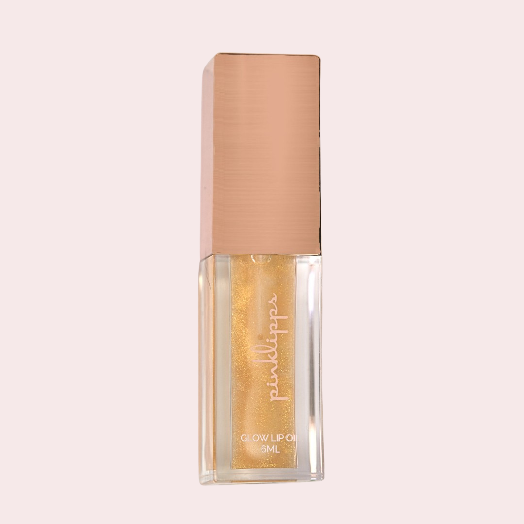 Pink Lipps 'Vanilla Sky' Glow Lip Oil tube on white background, vanilla scent vegan high-shine golden with sparkles lip oil for every shade of melanin.